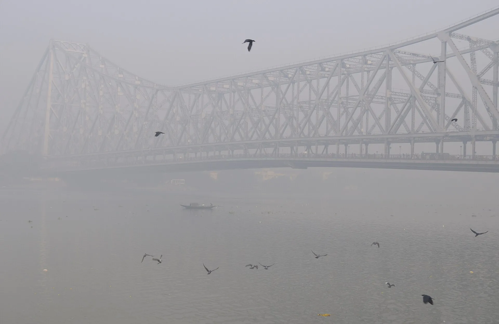 Howrah Bridge over the Hooghly river in Kolkata on a foggy morning